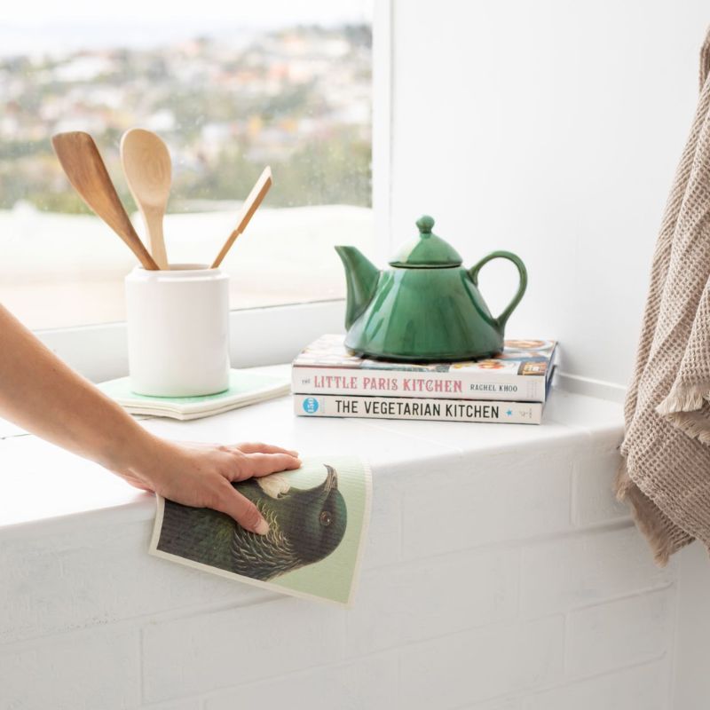 Set of 3 Swedish dish cloths by 100%NZ featuring native New Zealand birds - tui, kingfisher, and kakapo - in a soft, muted colour palette.