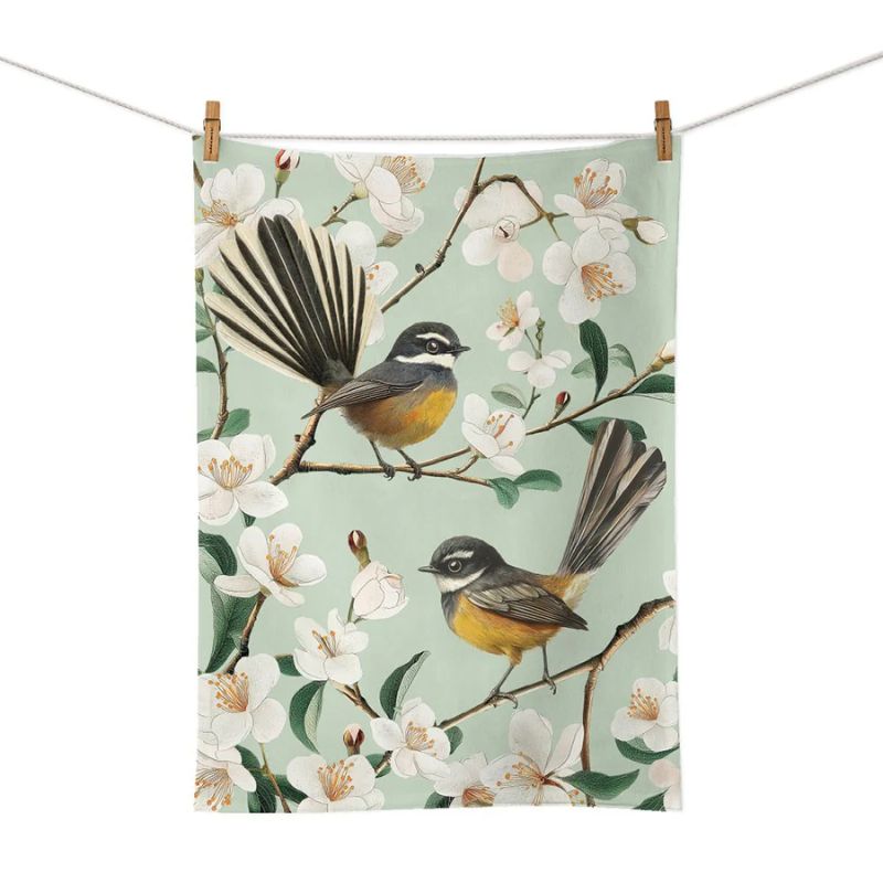 Chatty Fantails Tea Towel by 100%NZ featuring two fantails amongst blossom on a pale green background.