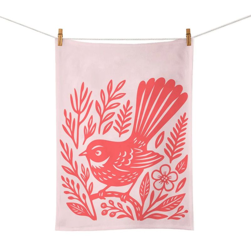 100%NZ Woodcut Fantail Tea Towel pegged to a line, shown against a white background.