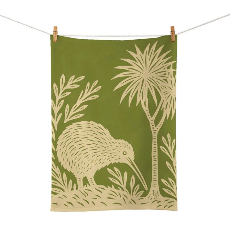 100%NZ Woodcut Kiwi Tea Towel shown pegged to a line against a white background.