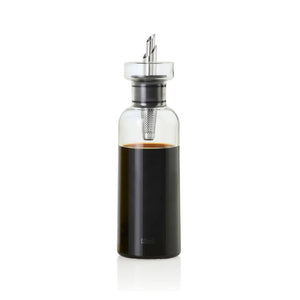 Glass vinegar dispenser with stainless steel spout and filter shown filled with vinegar