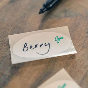 Agee jar label with Berry written on it, shown on a wooden surface with pen in the background.