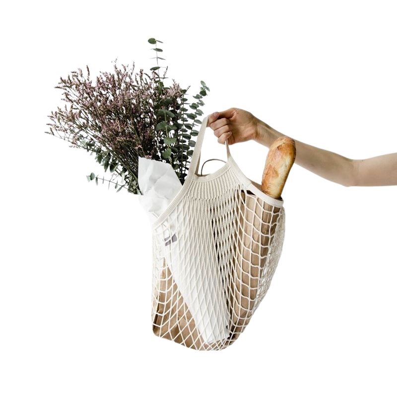 Appetito String Bag with Short Handles shown on a white background with bread and flowers inside.