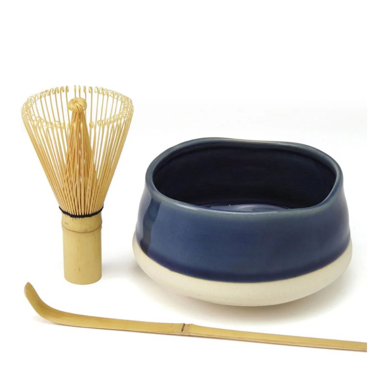 Avanti Matcha Ceremonial Set featuring a bamboo whisk, a dark blue ceramic bowl with a beige base, and a bamboo scoop on a white background.