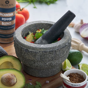Avanti Rough Mortar & Pestle - Grey (17 cm) with ingredients on a wooden board, including avocados and pepper.