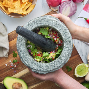 Avanti Rough Mortar & Pestle - Grey in 20 cm with chopped vegetables on a wooden board, surrounded by ingredients like tortilla chips and lime.
