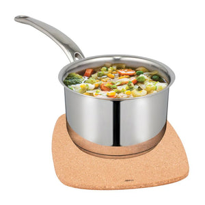 A stainless steel saucepan filled with mixed vegetables, resting on the Avanti Square Cork Trivet with Magnet against a white background.