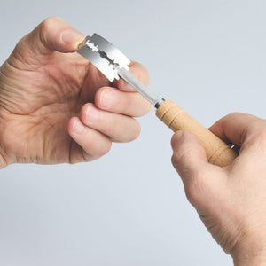 Hands replacing the blade on the Bakemaster Bread Lame.