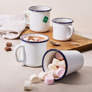 Bakemaster Enamel Mugs on a wooden board, one filled with hot chocolate and marshmallows, another with marshmallows.