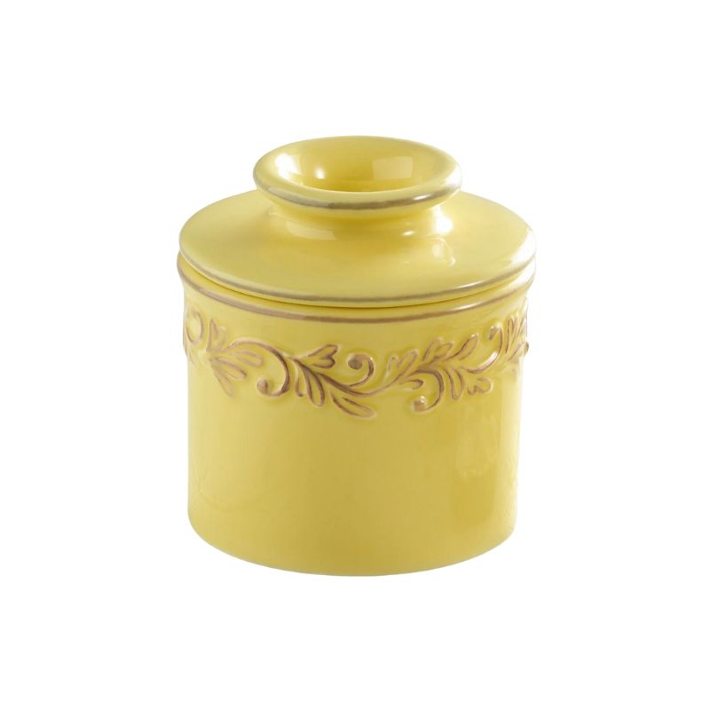 Goldenrod yellow Butter Bell Crock with embossed vine design, shown on a white background