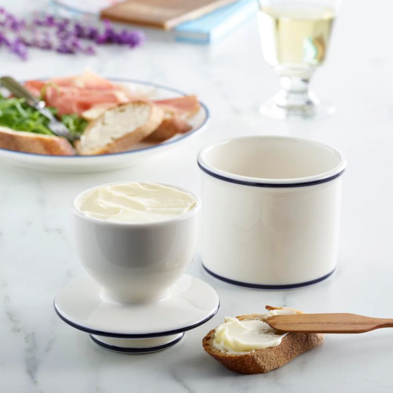 Le Bistro Butter Bell Crock with French blue detailing on off-white ceramic, shown on a plain white background