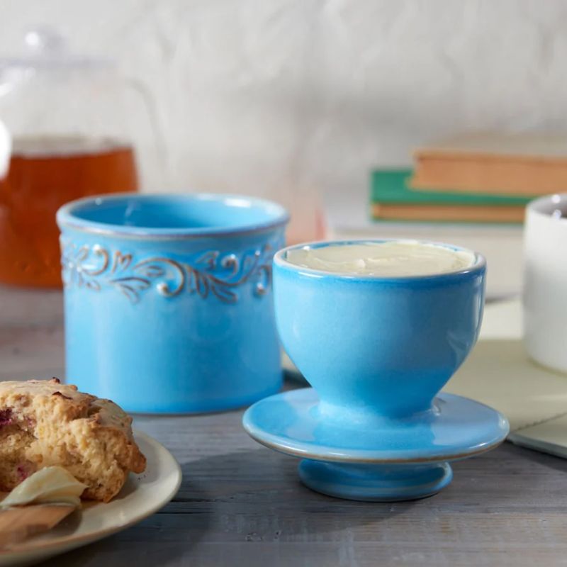 Front view of the Bleu Clair Butter Bell Crock in light blue with embossed vine detailing and a glossy finish