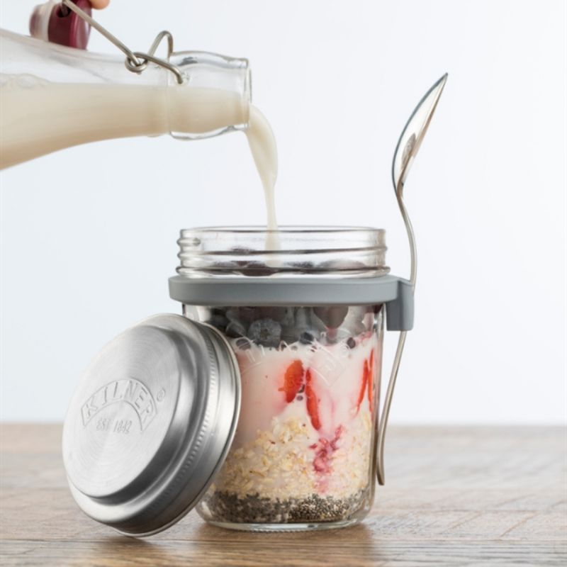Kilner 350 mL Breakfast Jar with stainless steel lid, silicone band, and spoon attached.