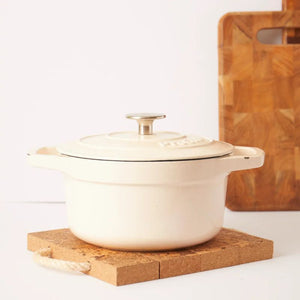 Natural cork trivet used under a white casserole dish.