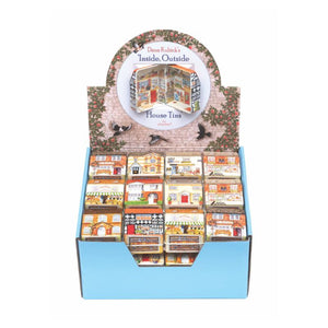 Display of 'Inside, Outside' house tin collection by Dana Kubick with a circular top showing the inside of the tudor tin.