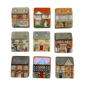 Close-up view of the fronts of the Dana Kubick Inside, Outside House Tins.