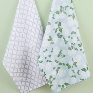 Design Imports Hydrangea Garden Tea Towels hanging against a green wall.