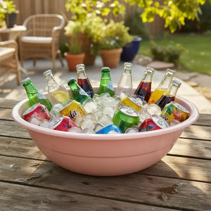 Dishy Enamel Large Basin in Clay Pink shown styled with drinks and ice.