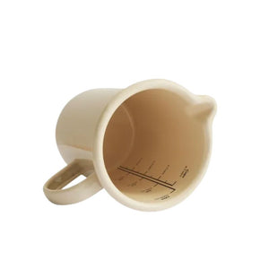 Dishy Enamel Measuring Jug in Almond shown side on against a white background.