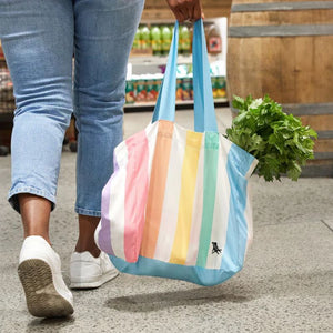Woman holding Dock & Bay Foldaway Tote Bag - Unicorn Wave full of groceries | NZ