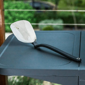 Dreamfarm BBQ Chopula resting on the side shelf of an outdoor BBQ grill.