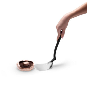 Hand holding the Dreamfarm BBQ Chopula lifting a cooked mushroom.