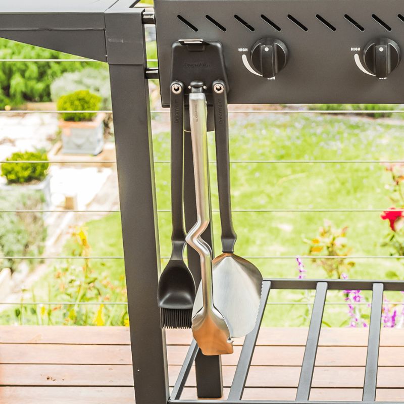 Close-up of Dreamfarm BBQ Grill Tools Set hanging from barbecue.