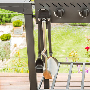 Close-up of Dreamfarm BBQ Grill Tools Set hanging from barbecue.