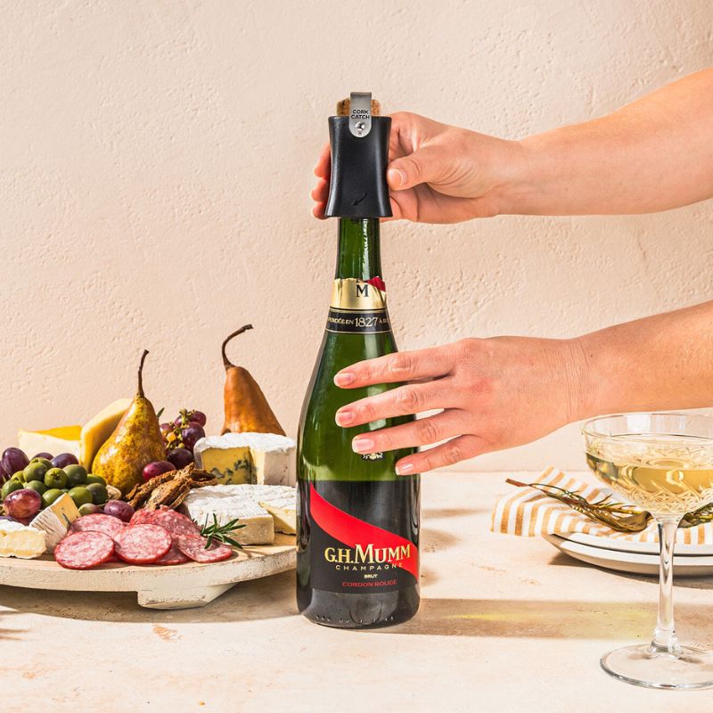 Hands using Dreamfarm Champop to twist and remove a Champagne cork