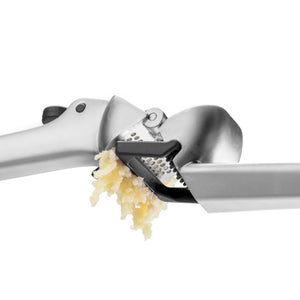 Dreamfarm Garject garlic press showing the scraper function to remove the pressed garlic | NZ