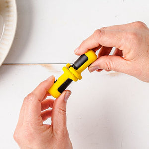 Hands holding Dreamfarm Lockorns corn cob holders shown locked together