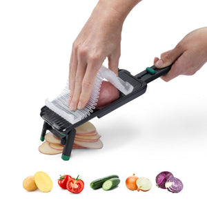 Dreamfarm Nocutu mandoline slicing vegetables using the hand guard