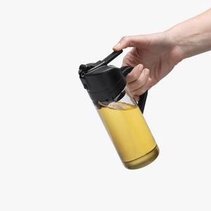 Person holding the Dreamfarm Oileroo on a white background.