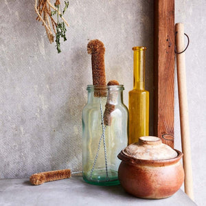 Glass bottle holding collection of Eco Max bottle brushes
