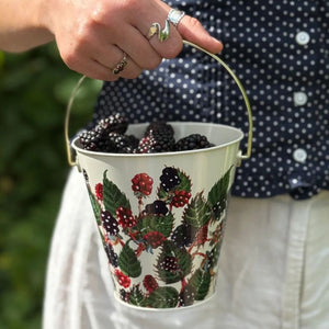 Emma Bridgewater Blackberries Foraging Bucket being carried, filled with freshly picked blackberries.