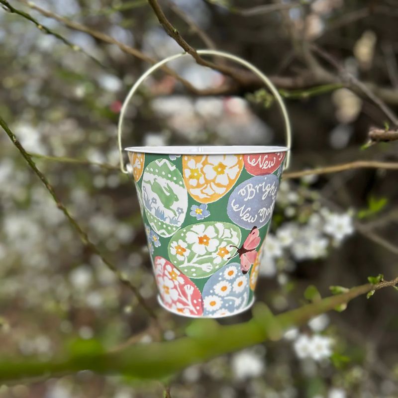 Emma Bridgewater Easter Egg Hunt metal bucket with handle, decorated with colourful patterned eggs, flowers, and a butterfly.