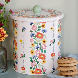Emma Bridgewater Poppies Biscuit Barrel shown next to flowers and biscuits.