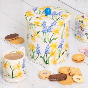 Emma Bridgewater Spring Biscuit Barrel shown next to a coordinating mug and biscuits.