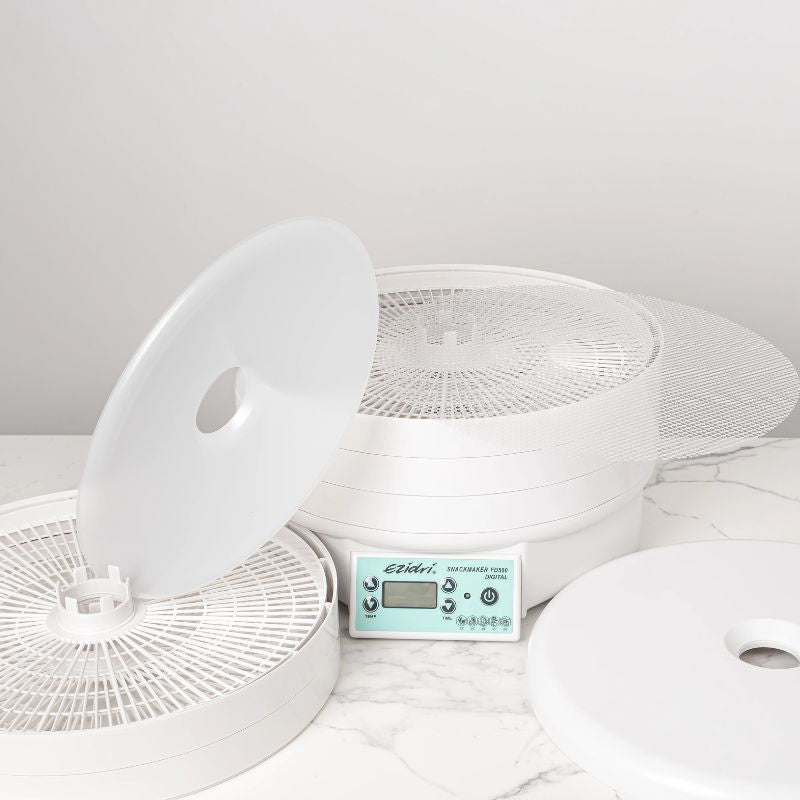 Ezidri FD500 Digital Dehydrator disassembled - showing trays, solid and mesh sheets, and removable lid