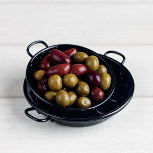 Garcima Spanish Enamel Tapas Dishes stacked on a wooden surface filled with olives.