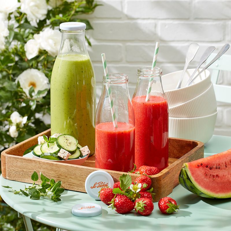 Le Parfait glass bottles filled with green and red juices, served with fresh fruit and vegetables - perfect for juices, smoothies, and pantry use in NZ kitchens.