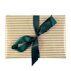 Gold and white striped glossy gift wrap with a wide spruce green ribbon
