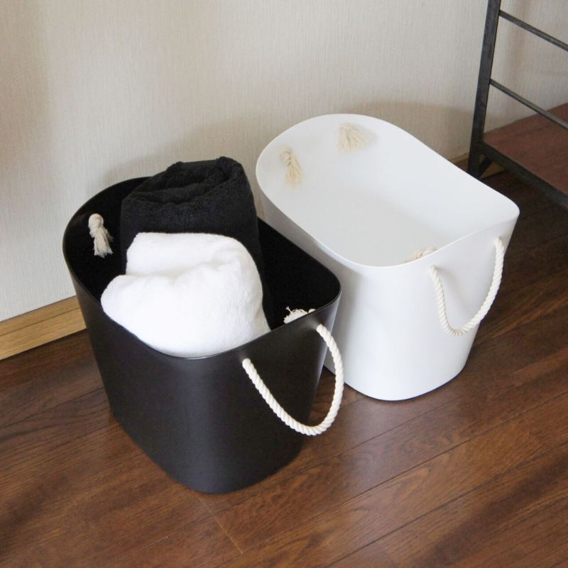 19L Hachiman Balcolore Storage Basket in both black and white being used to hold folded towels