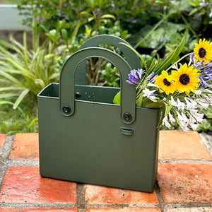 Hachiman Garden Tool Bag being used to hold flowers - seen on a brick garden path