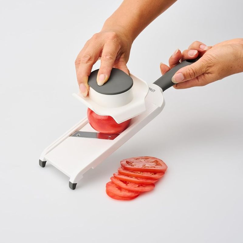Avanti Hand Held Mandoline Slicer with white body and grey handles and non-slip feet