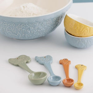 Mason Cash measuring spoons displayed beside matching mixing bowls – part of the Home to Roost collection.