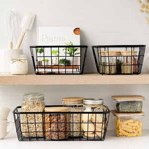 Medium and large sized black wire baskets from the Kate's Kitchen range shown on kitchen shelves.