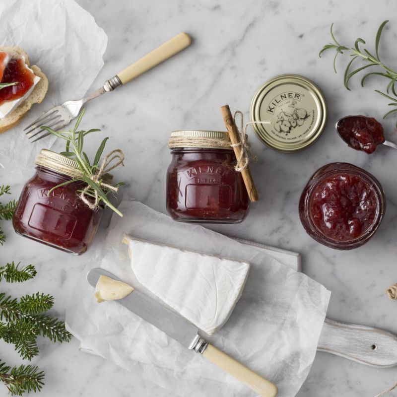 An assortment of Kilner 250mL preserving jars with regular mouth opening - displayed with cheese, herbs and bread