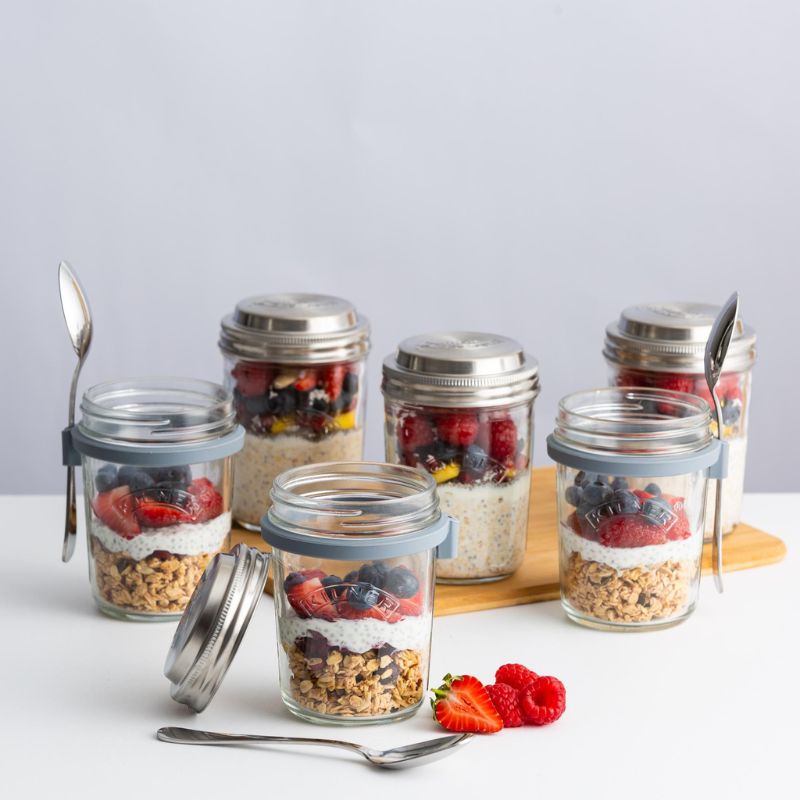 Multiple Kilner Breakfast Jars filled with different layered breakfast recipes, displayed with fruit and oats.