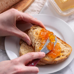 Person spreading marmalade on a slice of bread with the Kilner Butter Spreader.